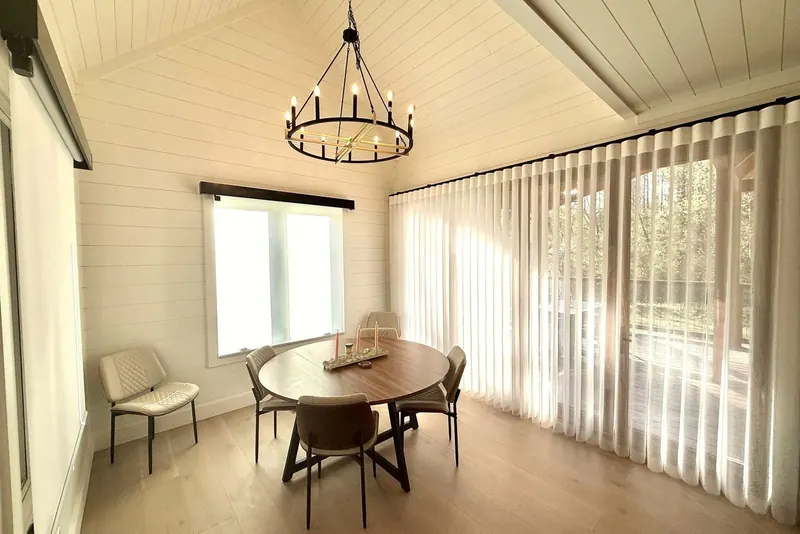 Norman SmartDrape drawn across a wall of sliding doors in a dining room